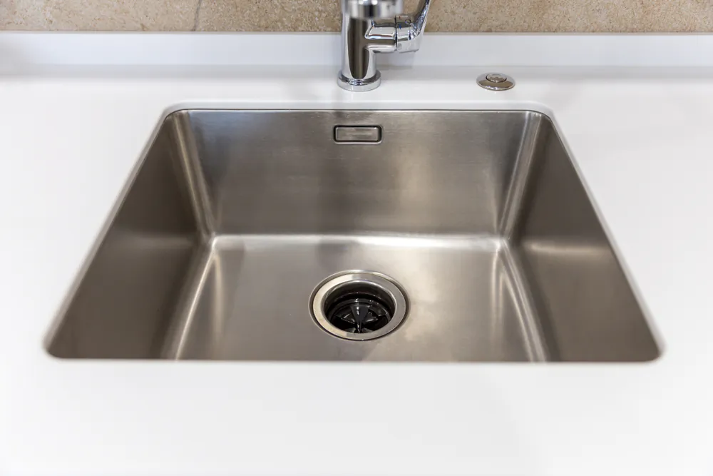Clean the disposal every few days by pouring in a dash of dish soap and running cool water through it. (mariakray/Shutterstock)