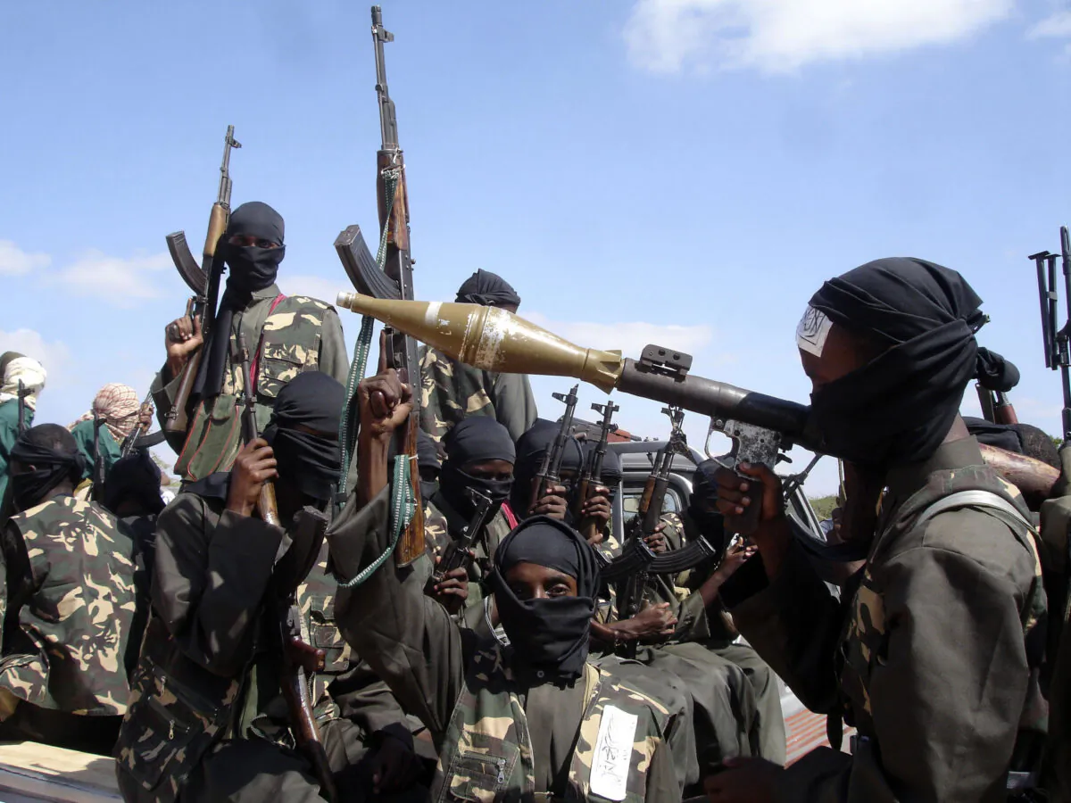 Armed al-Shabab terrorists ride on pickup trucks as they prepare to travel into the city, just outside the capital Mogadishu, in Somalia, on Dec. 8, 2008. (Farah Abdi Warsameh/AP Photo)