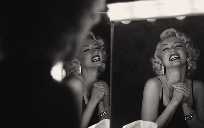 woman looking at mirror in BLONDE