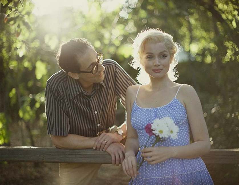 man and woman standing at a fence in BLONDE