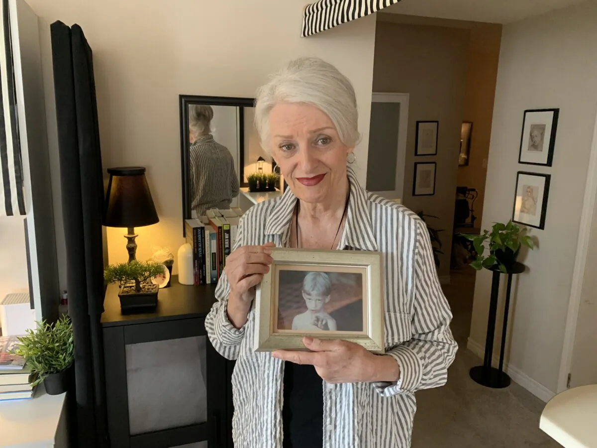 Sharon Danley holds a photo of her son, Matthew, as a boy, at her apartment in Toronto on Sept. 27, 2022. (Peter Wilson/The Epoch Times)