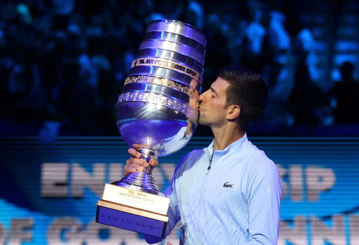 Serbia's Novak Djokovic poses with the trophy after winning the final match against Croatia's Marin Cilic in Tel Aviv Open, Israel, on Oct. 2, 2022. (Nir Elias/Reuters)