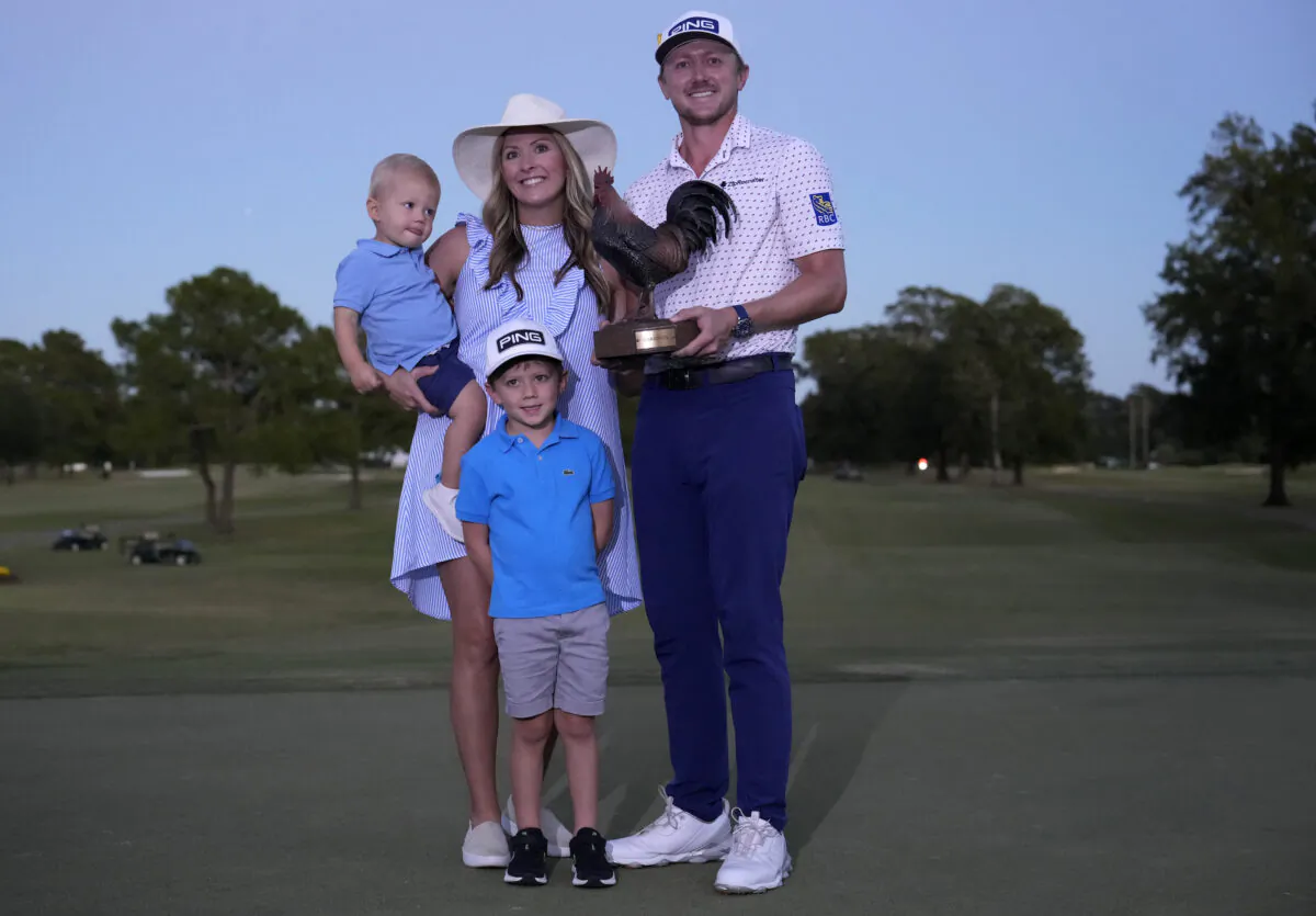 Mackenzie Hughes of Canada reacts with his family after putting in to win on the second playoff hole against Sepp Straka of Austria on the 18th green during the final round of the Sanderson Farms Championship at The Country Club of Jackson in Jackson, Miss., on Oct. 2, 2022. (Raj Mehta/Getty Images)