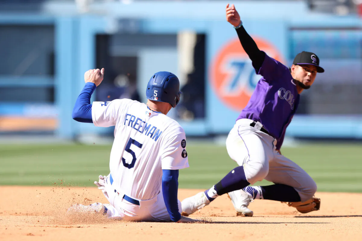 Freddie Freeman (5) of the Los Angeles Dodgers slides into second as he is tagged out by Ezequiel Tovar (14) of the Colorado Rockies in the sixth inning at Dodger Stadium in Los Angeles, on Oct. 2, 2022. (Katharine Lotze/Getty Images)