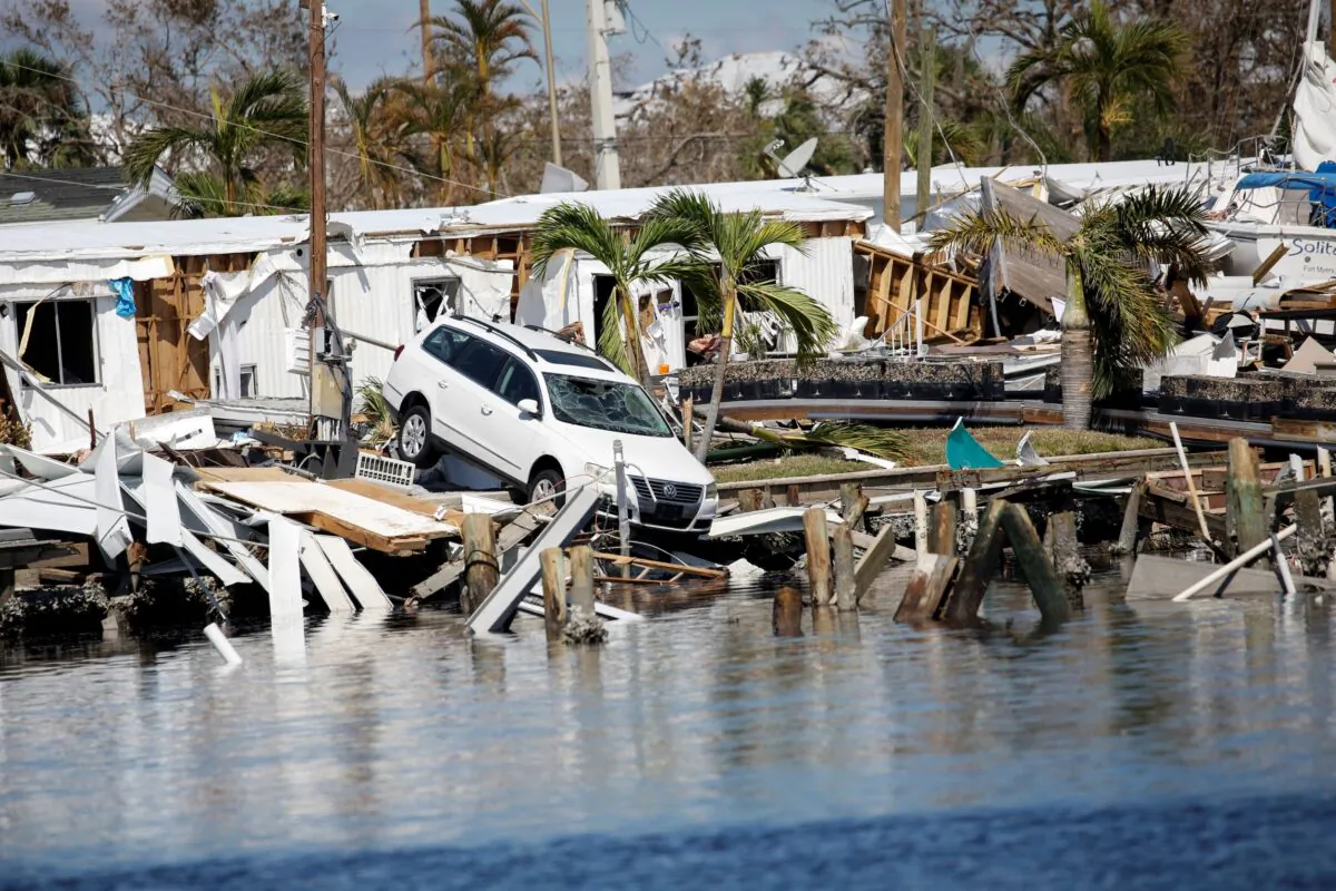 A destroyed car in the Matanzas Pass after Hurricane Ian caused widespread destruction in Fort Myers Beach, Fla., on Oct. 1, 2022. (Marco Bello/Reuters)
