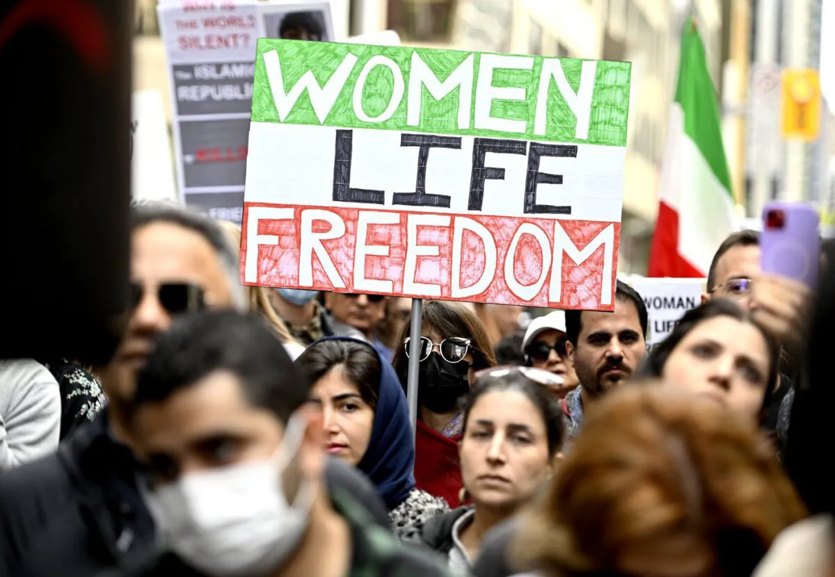 Members of the Iranian community and their supporters rally in solidarity with protesters in Iran, after 22-year-old Mahsa Amini died in police custody for allegedly improperly wearing a hijab, in Ottawa on Sept. 25, 2022. (The Canadian Press/Justin Tang)