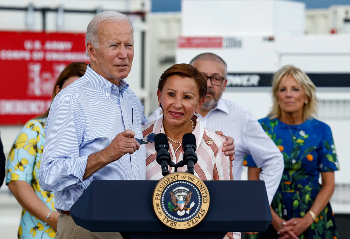 President Joe Biden embraces Chairwoman Nydia Velazquez as he delivers remarks at Port of Ponce, Puerto Rico, on Oct. 3, 2022. (Evelyn Hockstein/Reuters)