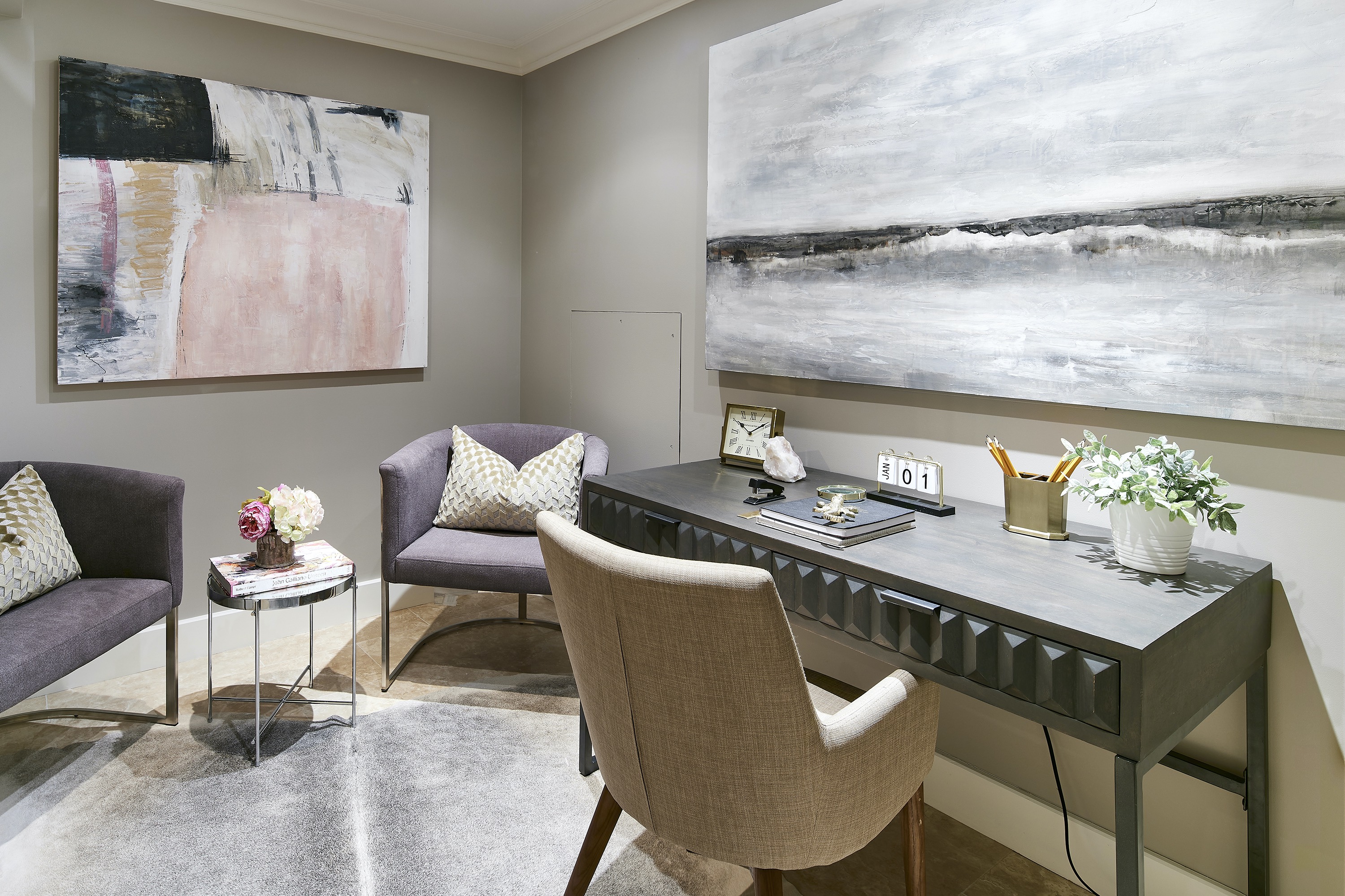 A windowless room is made brighter through the use of artwork and light fabrics.