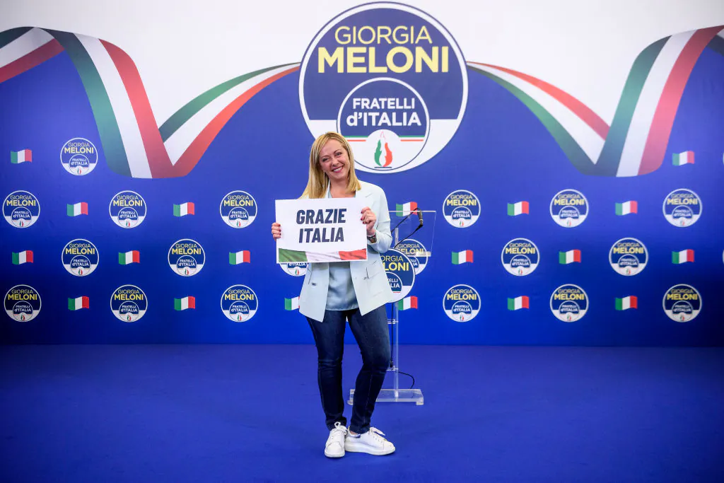 Giorgia Meloni, leader of the Fratelli d'Italia (Brothers of Italy) holds a "Thank You Italy" sign during a press conference at the party electoral headquarters overnight in Rome, Italy, on Sept. 25, 2022. (Antonio Masiello/Getty Images)