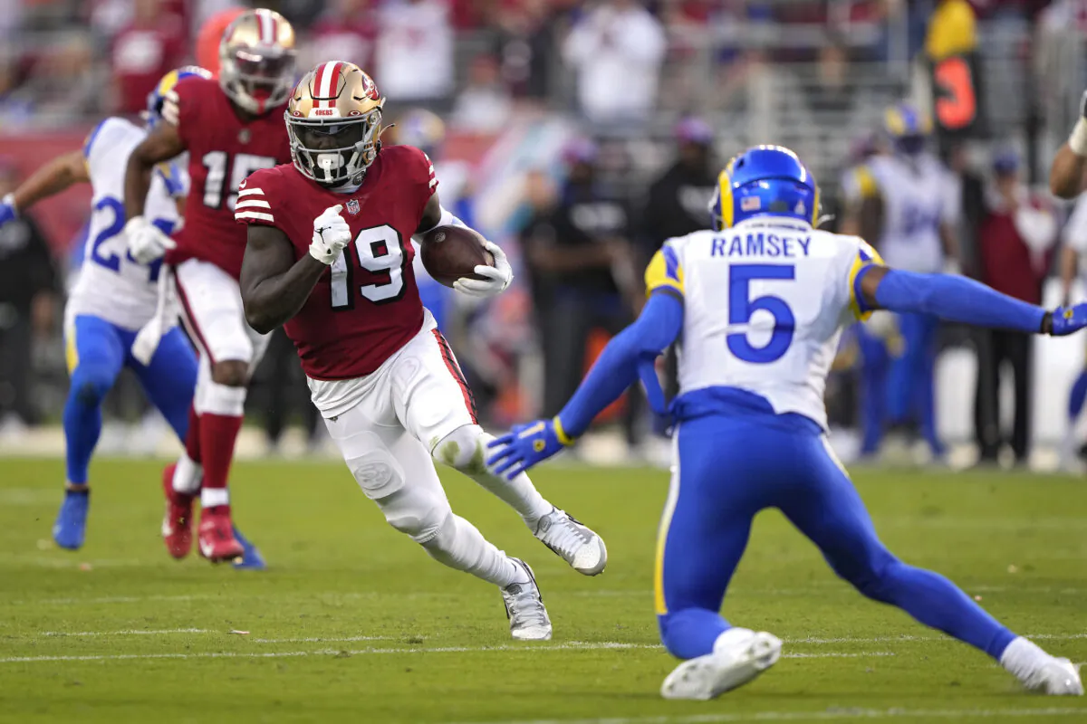 Wide receiver Deebo Samuel (19) of the San Francisco 49ers rushes for a touchdown as he breaks a tackle by cornerback Jalen Ramsey (5) of the Los Angeles Rams during the second quarter at Levi's Stadium in Santa Clara, Calif., on Oct. 3, 2022. (Thearon W. Henderson/Getty Images)