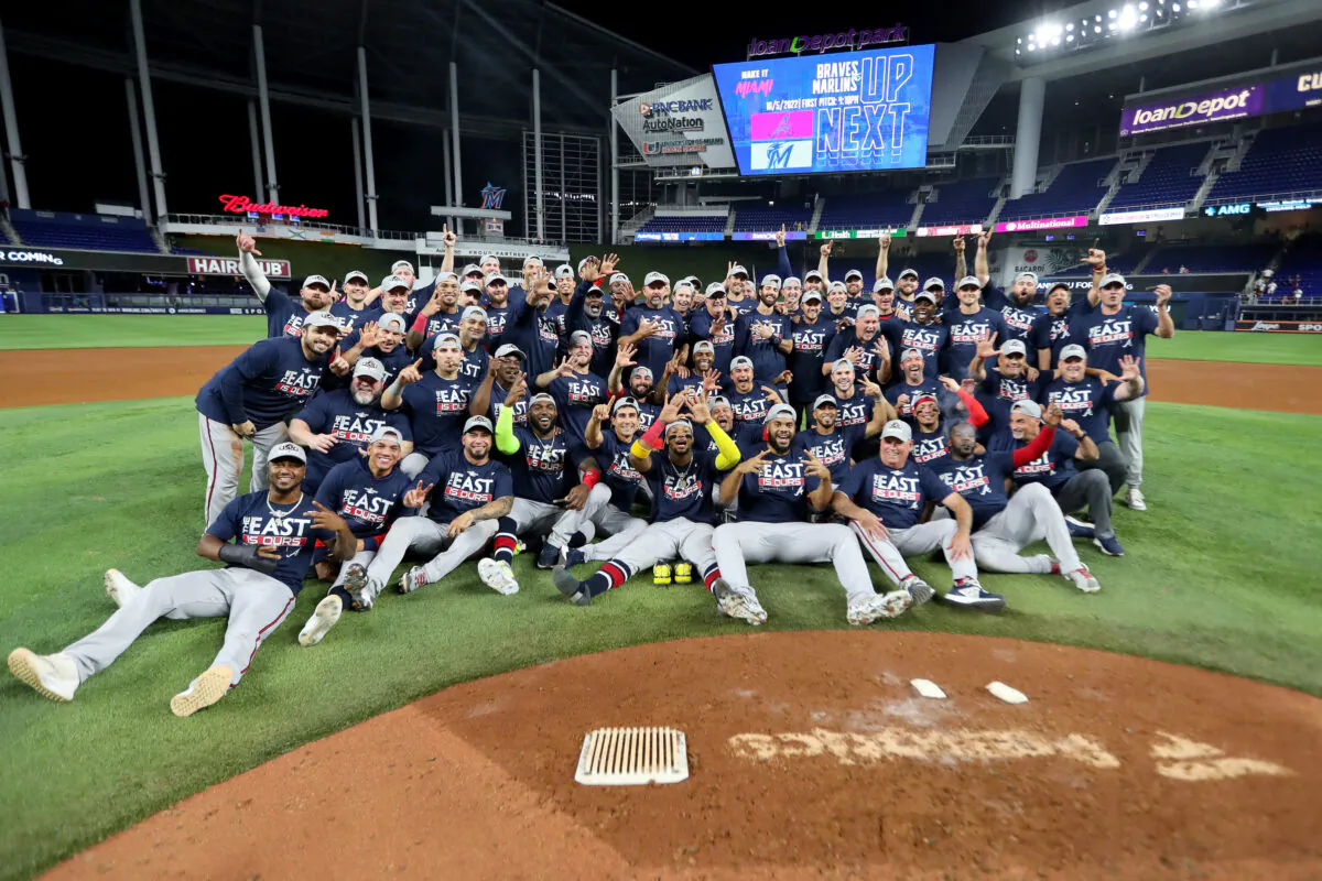 The Atlanta Braves pose for a group picture after clinching the division against the Miami Marlins at loanDepot park in Miami, on Oct. 4, 2022. (Megan Briggs/Getty Images)
