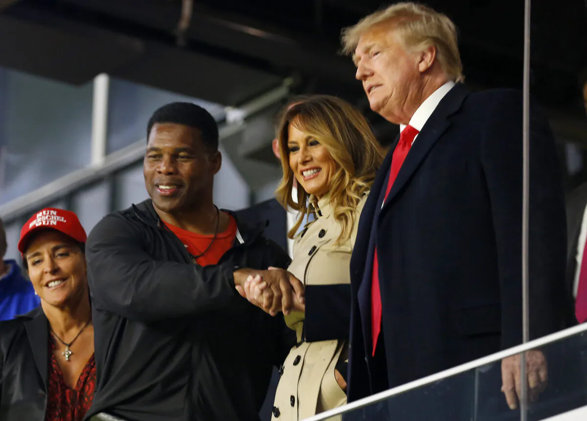 Former football player and political candidate Herschel Walker interacts with former U.S. President Donald Trump prior to Game Four of the World Series between the Houston Astros and the Atlanta Braves at Truist Park in Atlanta on Oct. 30, 2021. (Michael Zarrilli/Getty Images)