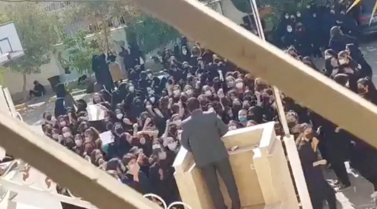 Female protesters react and chant towards a man standing at a podium in Shiraz, Fars province, Iran, on Oct. 4, 2022, in this still image from a video obtained by Reuters. (Reuters)
