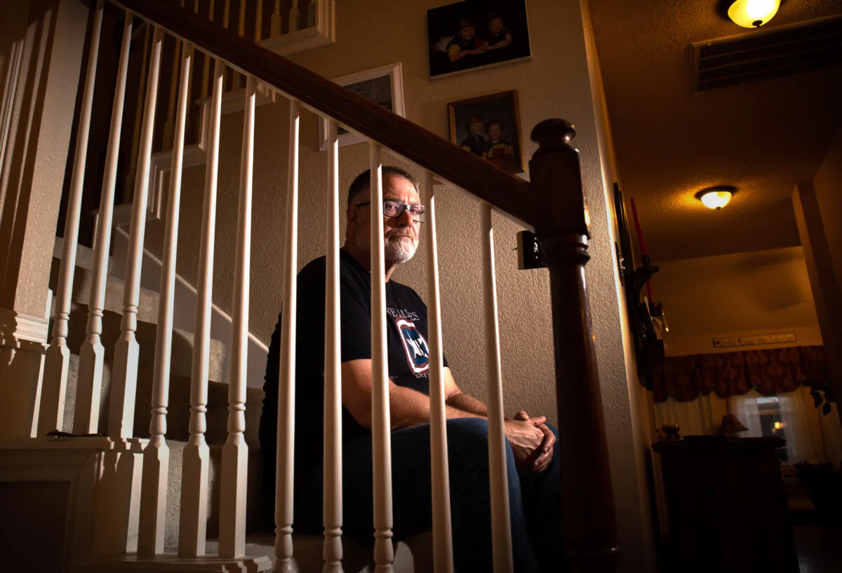 Jeff Younger, a father who fought to keep his ex-wife from being able to seek "gender-affirming" surgery for their pre-teen son in California, sits on a staircase at his home in Flower Mound, Texas, on Sept. 16, 2022. (Bobby Sanchez for The Epoch Times)
