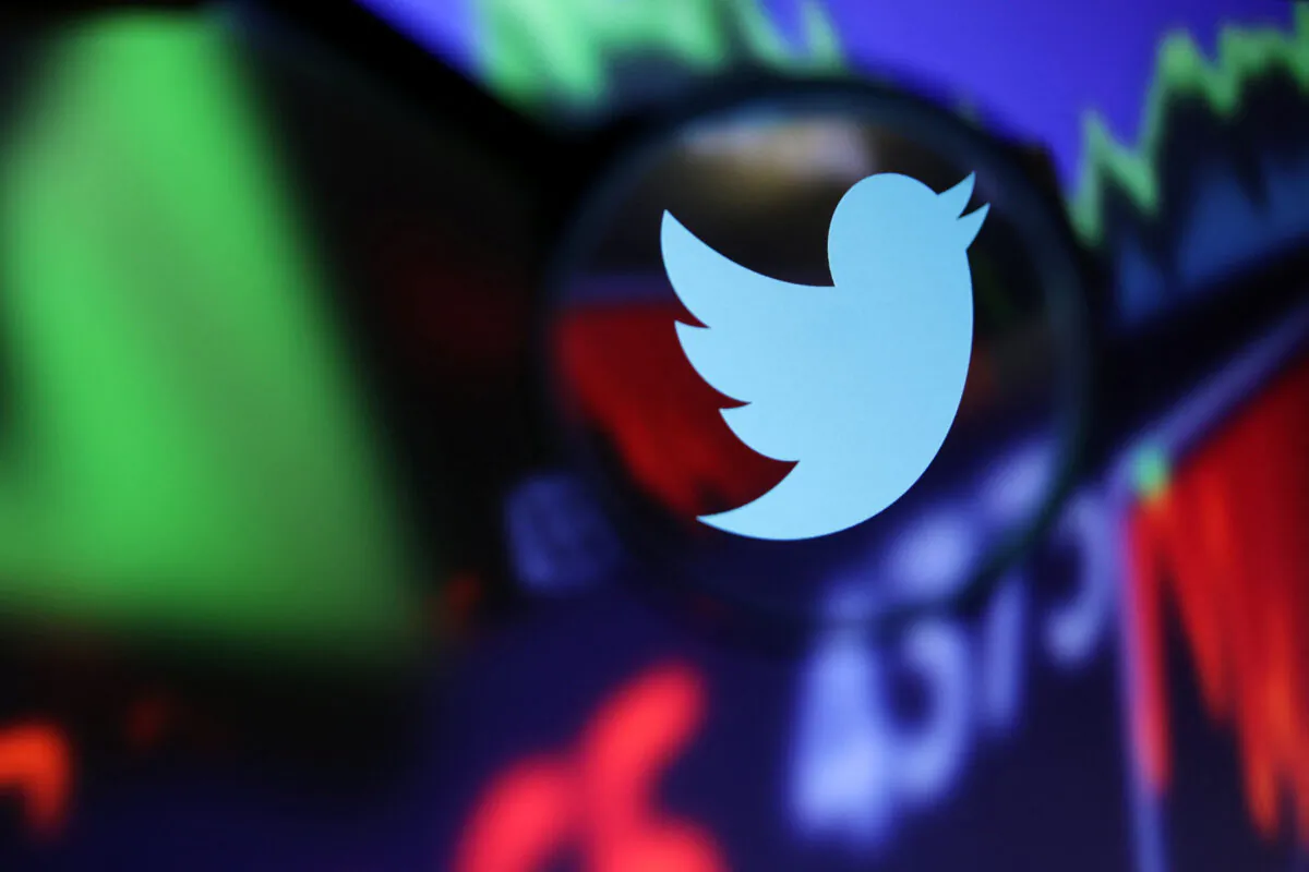 Twitter logo and stock graph through a magnifier displayed in this illustration on Sept. 4, 2022. (Dado Ruvic/Illustration/Reuters)
