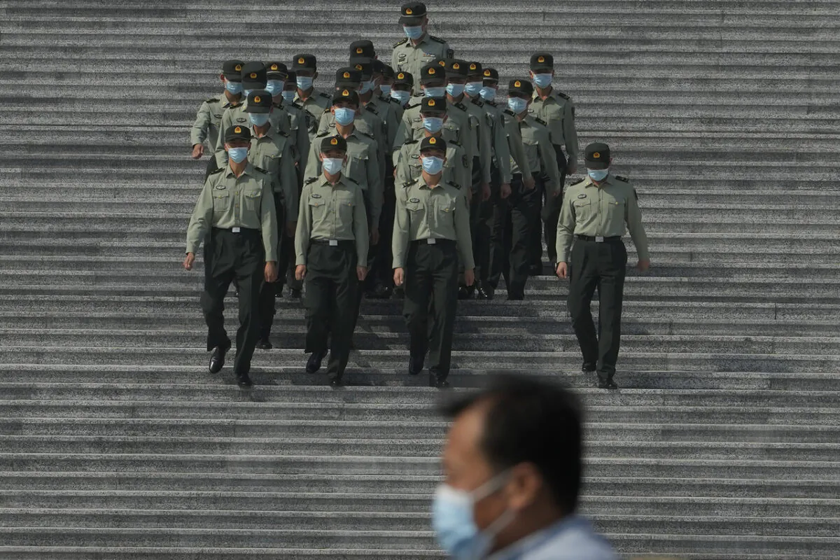 Chinese military officers are pictured marching down the steps of the Great Hall of the People in Beijing, on Sept. 27, 2022. (AP Photo/Ng Han Guan)