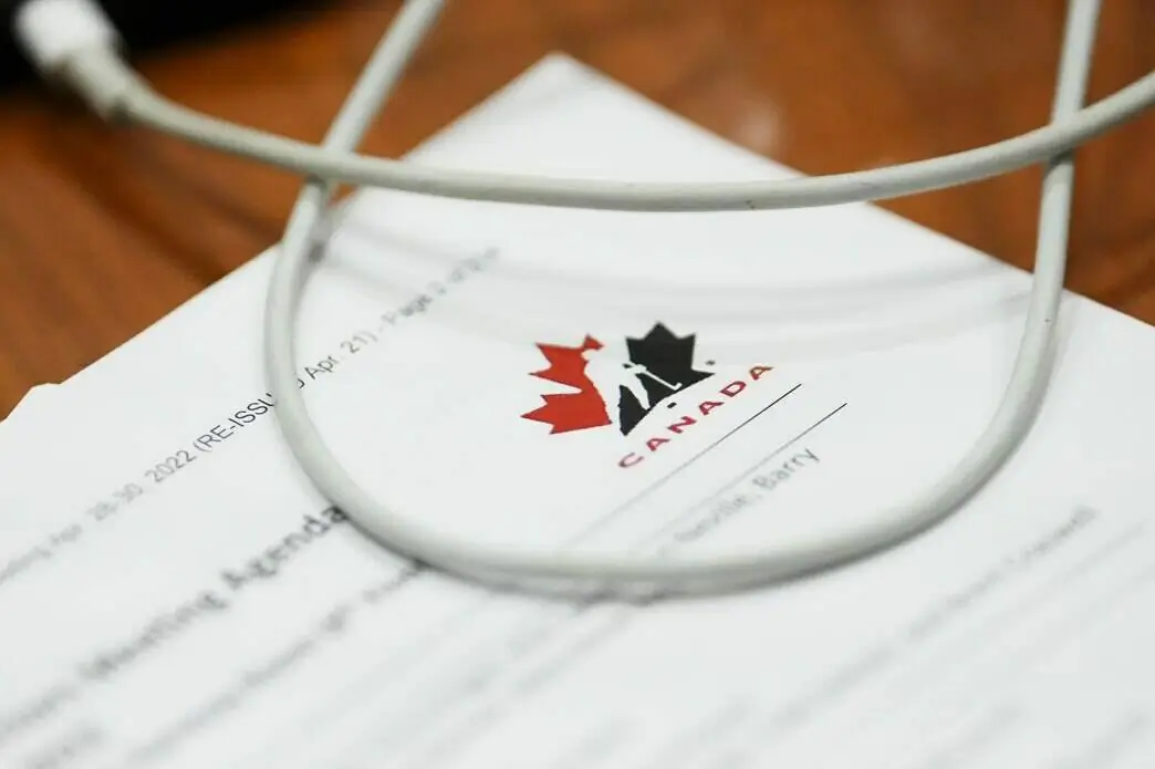 A Hockey Canada document is review by a member of Parliament during a House of Commons Committee on Canadian Heritage looking into safe sport in Canada on Parliament Hill in Ottawa on Oct. 4, 2022. (The Canadian Press/Sean Kilpatrick)