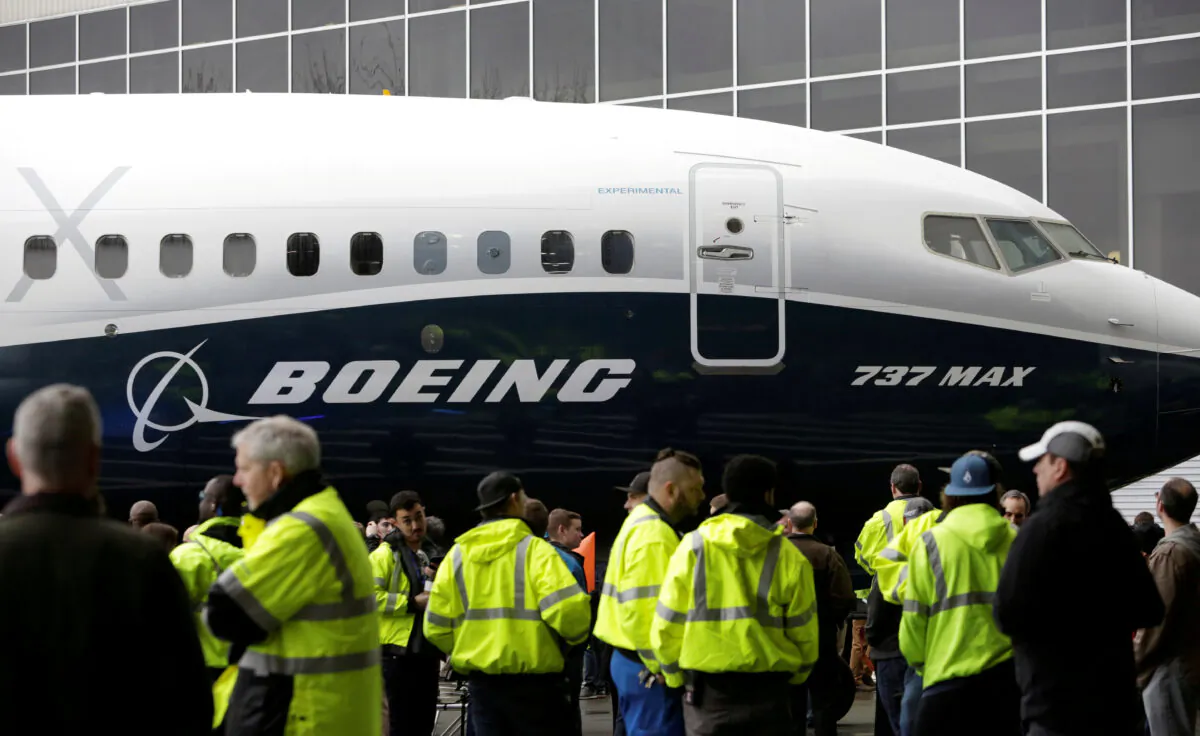Employees are pictured as the first Boeing 737 MAX 7 is unveiled in Renton, Washington on Feb. 5, 2018. (Jason Redmond/Reuters)