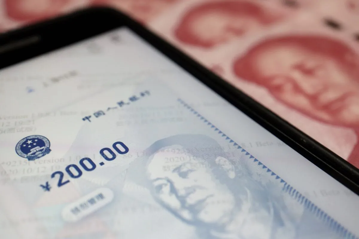 China's official app for digital yuan on a mobile phone next to 100-yuan banknotes on Oct. 16, 2020. (Florence Lo/Illustration/Reuters)