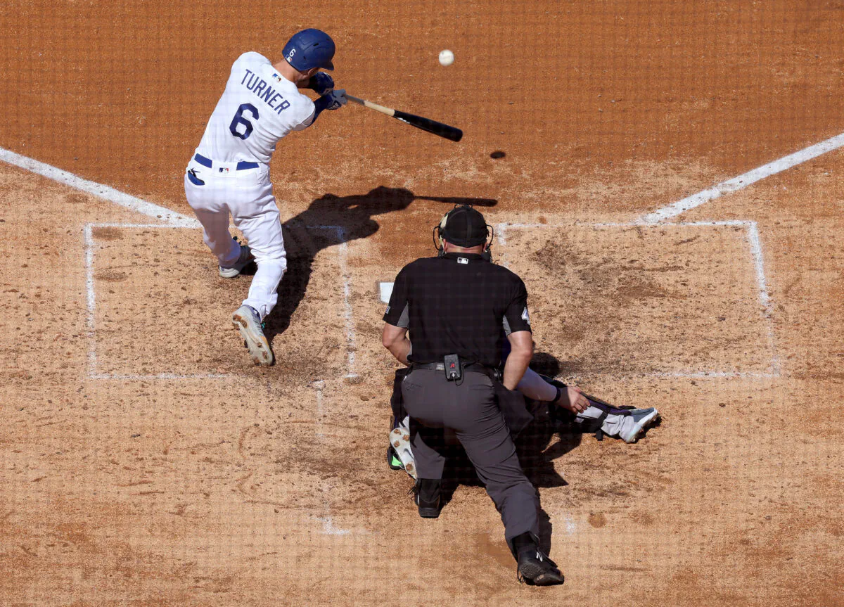Trea Turner (6) of the Los Angeles Dodgers hits a three run homerun, to take a 4–1 lead over the Colorado Rockies, during the fifth inning at Dodger Stadium in Los Angeles, on Oct. 5, 2022. (Harry How/Getty Images)
