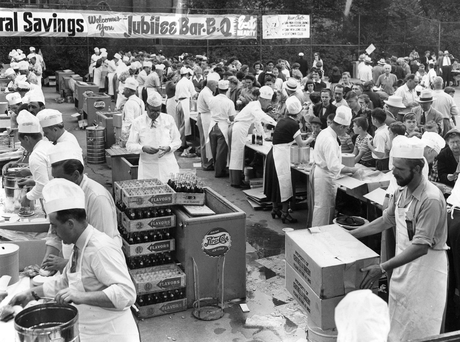 Oak Parkers celebrate the village's golden jubilee by downing a half-ton of barbecued meat, 7,200 buns and and uncounted bottles of pop in less than an hour in 1951.