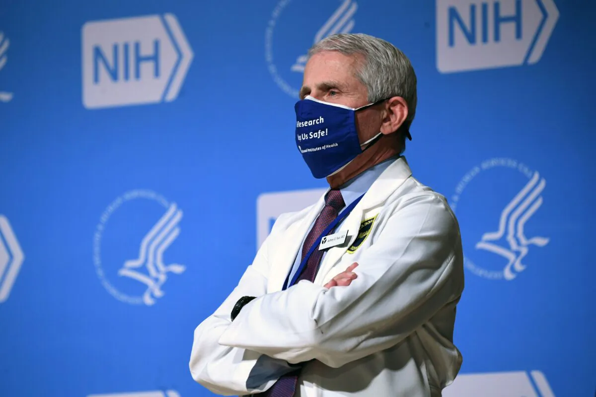 Then NIAID director Dr. Anthony Fauci listens to President Joe Biden (out of frame) speak during a visit to the National Institutes of Health (NIH) in Bethesda, Md., on Feb. 11, 2021. (Saul Loeb/AFP via Getty Images)