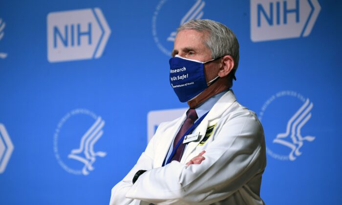NIAID Director Dr. Anthony Fauci listens to President Joe Biden (out of frame) speak during a visit to the National Institutes of Health (NIH) in Bethesda, Md., on Feb. 11, 2021. (Saul Loeb/AFP via Getty Images)