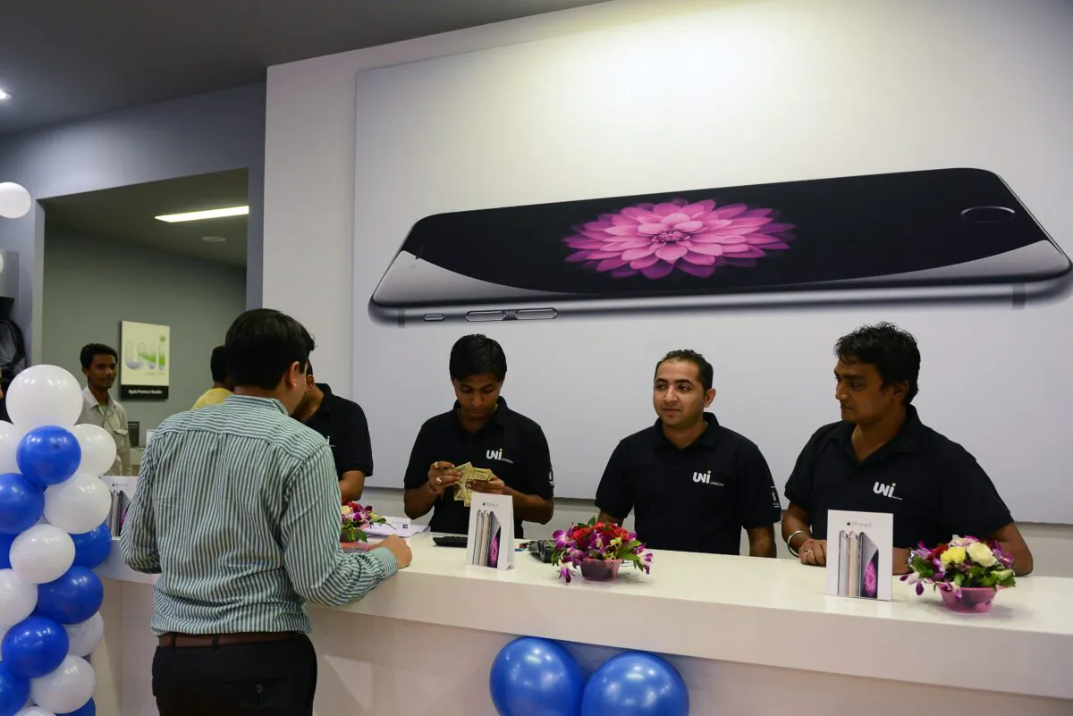 An Indian customer waits to receive his Apple iPhone 6 at the Unicorn Infosolutions Apple Premium Reseller store in Ahmedabad early on Oct. 17, 2014. (Sam Panthaky/AFP via Getty Images)