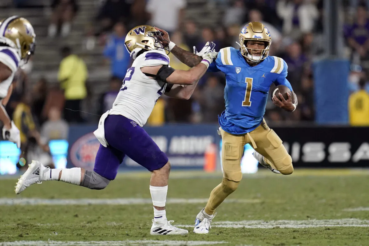 UCLA quarterback Dorian Thompson-Robinson (1) stiff-arms Washington linebacker Carson Bruener during the second half of an NCAA college football game in Pasadena, Calif., Sept. 30, 2022. (Marcio Jose Sanchez/AP Photo)