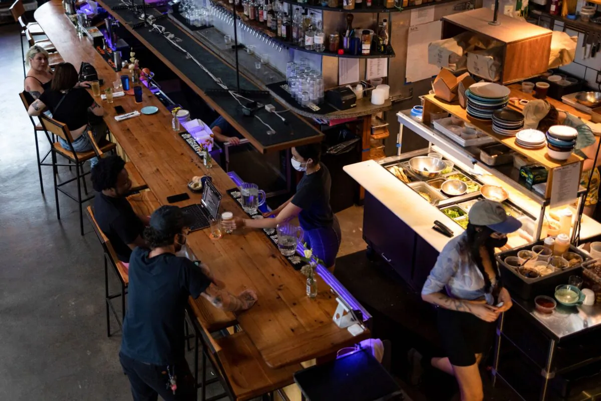 Customers drink and dine inside the restaurant "Martha" after showing proof of their coronavirus disease (COVID-19) vaccinations upon entering, in Philadelphia, Pa., on Aug. 7, 2021. (Hannah Beier/Reuters)