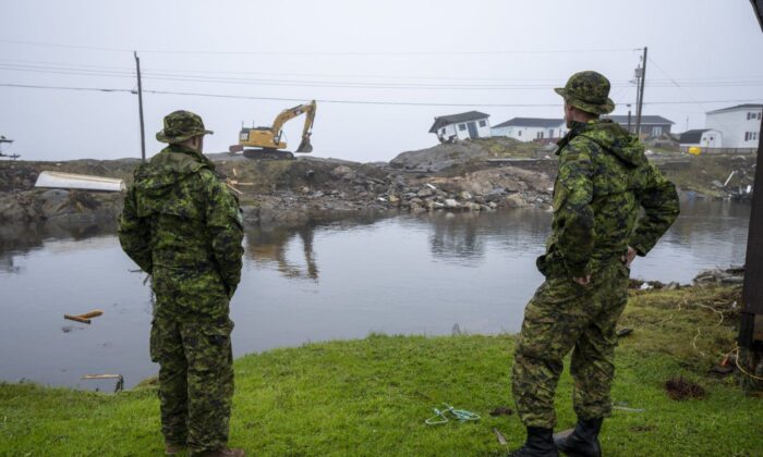 Canadian Armed Forces members from St John's survey   the devastation near  by post-tropical tempest  Fiona successful  Burnt Island, N.L., connected  Sept. 28, 2022. (The Canadian Press/Frank Gunn)
