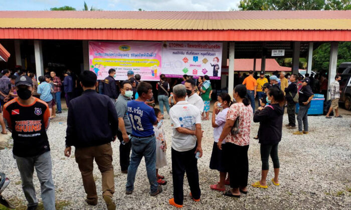 People gather outside of a daycare center's scene of a mass shooting in the town of Uthai Sawan, 500 km northeast of Bangkok in the Province of Nong Bua Lamphu, Thailand, on Oct. 6, 2022. (Sakdipat Boonsom/Handout via Reuters)