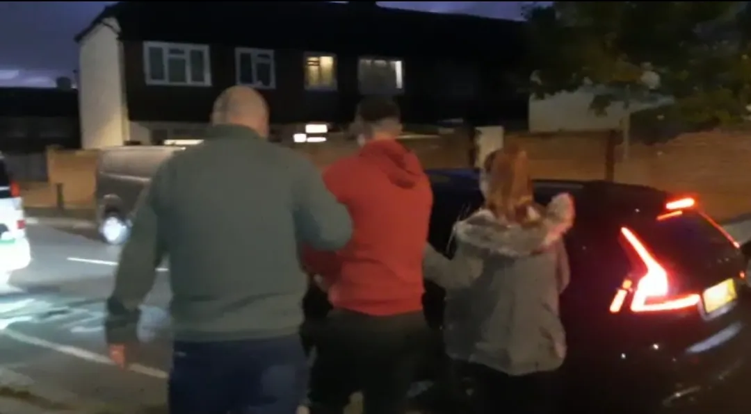A 30-year-old Albanian national is arrested by National Crime Agency officers in a dawn raid in Surbiton, southwest London, on Oct. 7, 2022. (National Crime Agency)