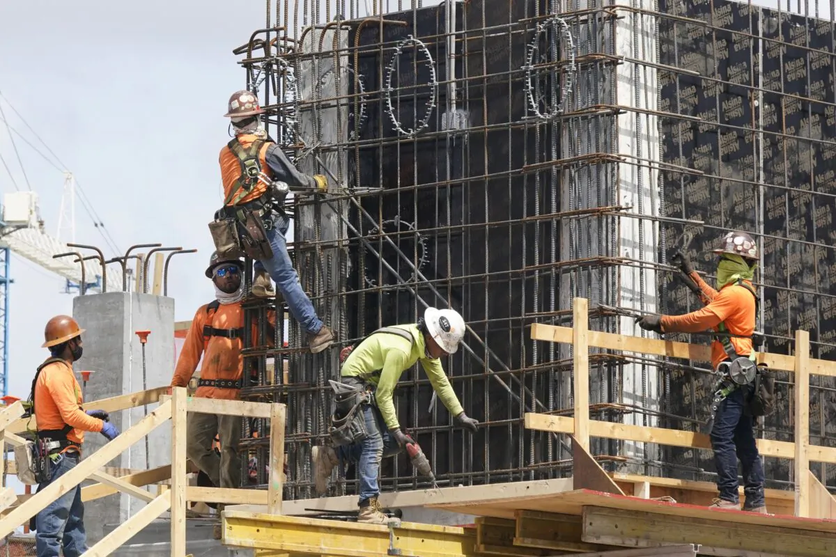 Construction workers fasten the frame of a new building in Miami, Fla., on May 3, 2021. (Marta Lavandier/AP Photo)
