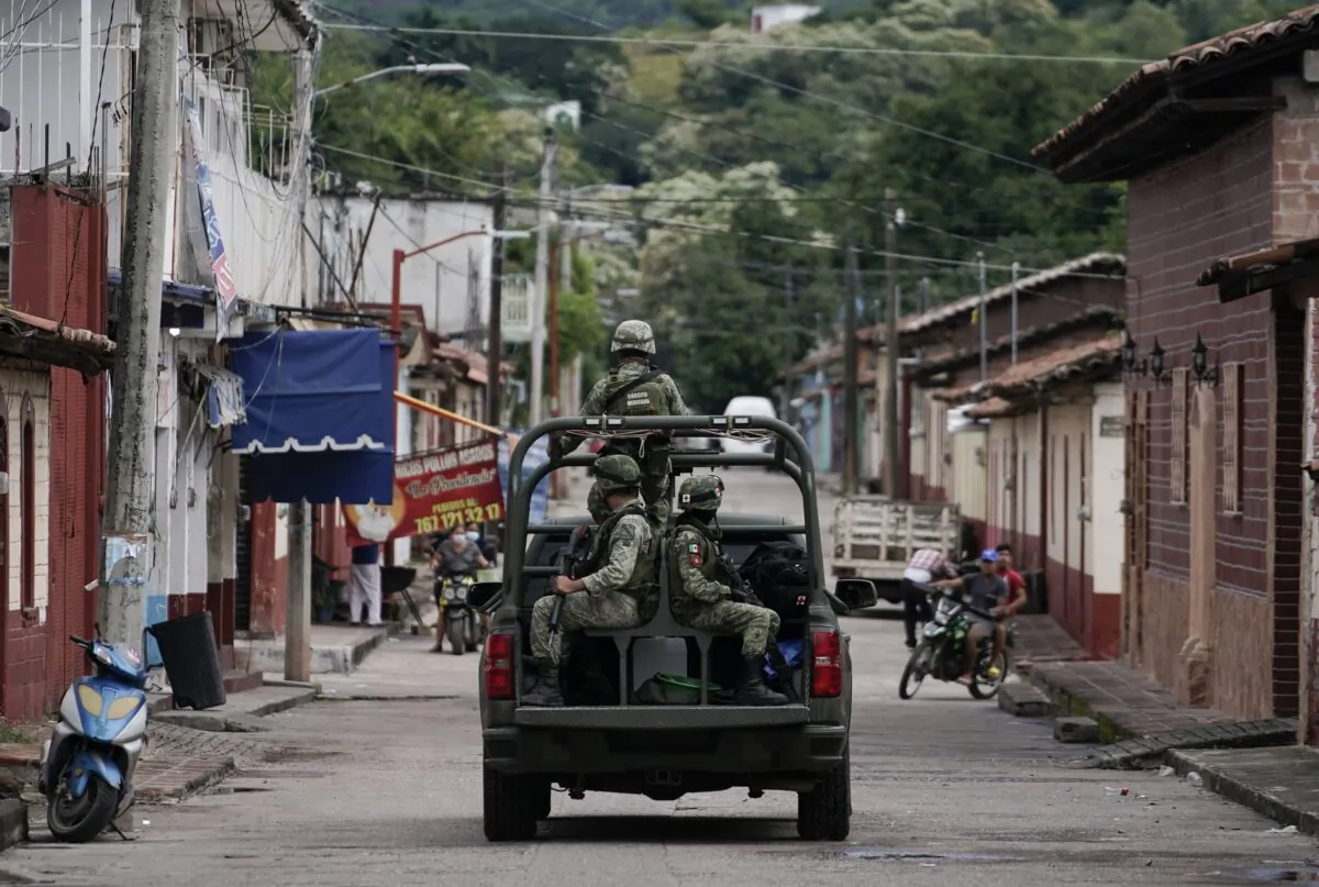 Soldier patrol in San Miguel Totolapan after a mass shooting in Mexico on Oct. 6, 2022. (Eduardo Verdugo/AP Photo)