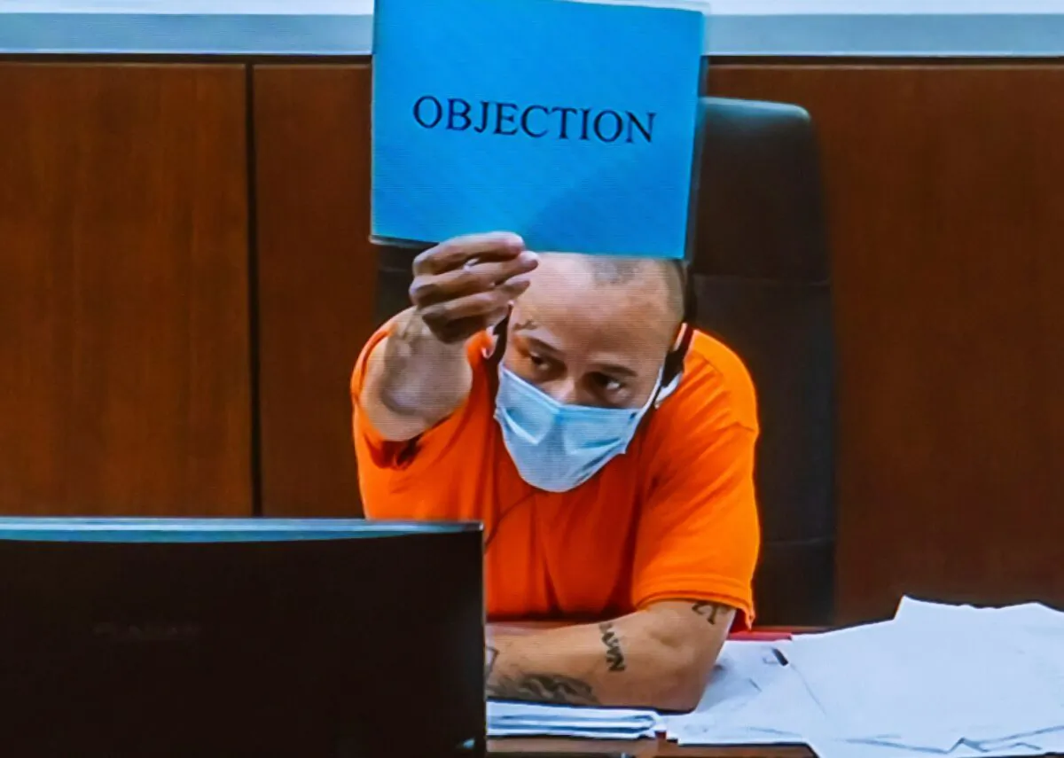 Darrell Brooks objects to testimony as he appears via video from an adjacent courtroom after being removed by Waukesha County Circuit Court Judge Jennifer Dorow for repeated interruptions in a Waukesha County Circuit Court during the third day of his trial in Waukesha, Wis., on Oct. 5, 2022. (Scott Ash/Milwaukee Journal-Sentinel via AP)