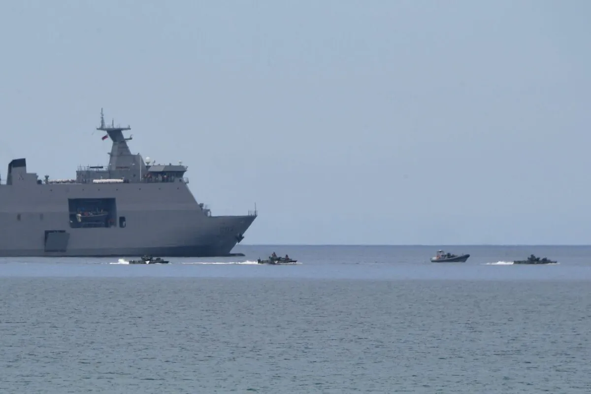 Philippine Marines' amphibious assault vehicles maneuver next to a Philippine BRP Tarlac navy landing platform dock ship during a joint amphibious landing exercise with U.S. Marines at a beach facing the South China Sea in San Antonio town, Zambales province, on Oct. 7, 2022. (Ted Aljibe/AFP via Getty Images)