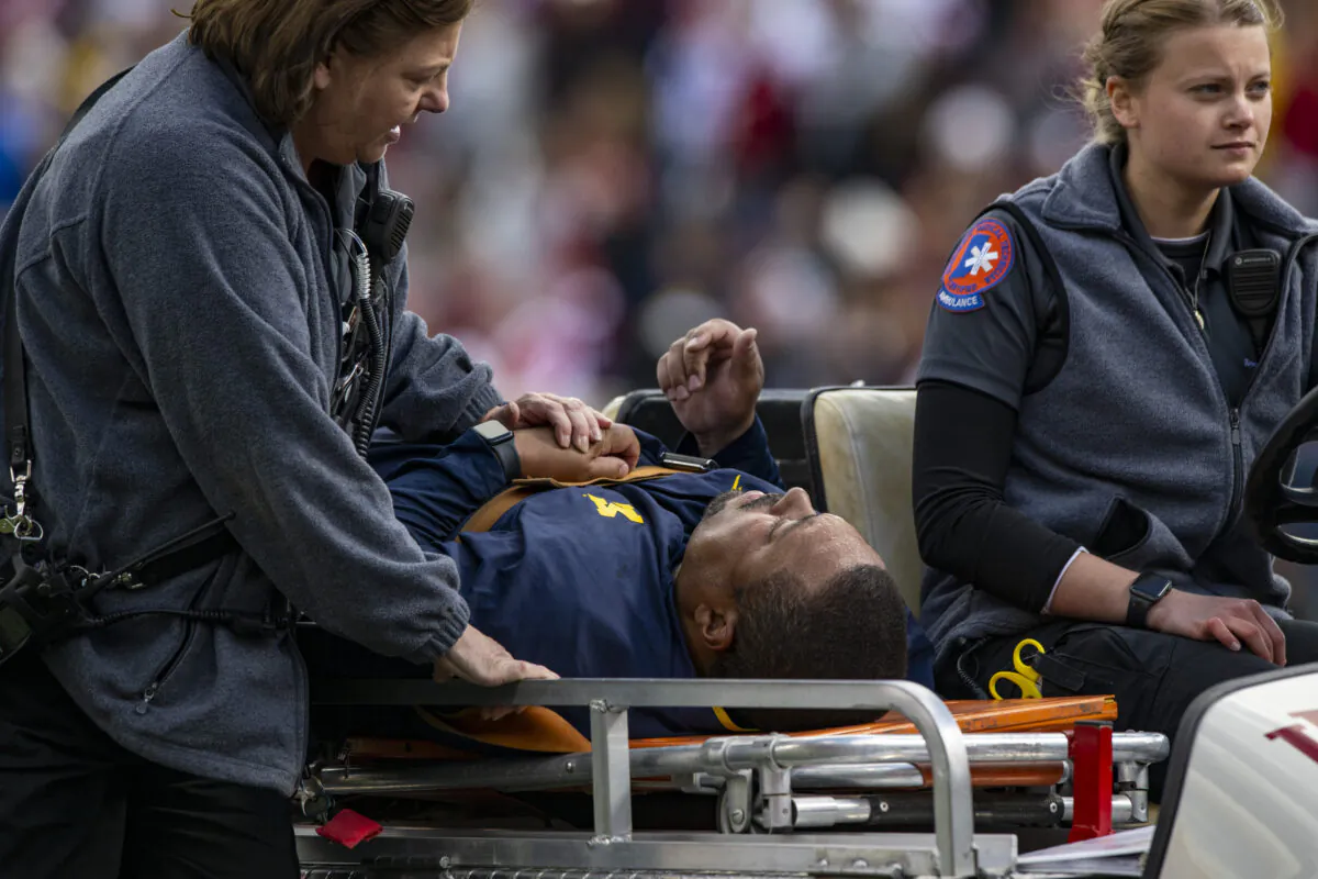 Michigan running game coordinator Mike Hart was carted off the field on a backboard during the first half of an NCAA college football game against Indiana in Bloomington, Ind., on Oct. 8, 2022. (Doug McSchooler/AP Photo)