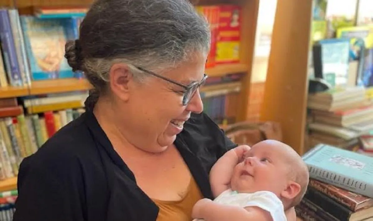 Heather Idoni holds her grandson at her bookstore in Linden, Mich., in a file image. (Courtesy of Heather Idoni)