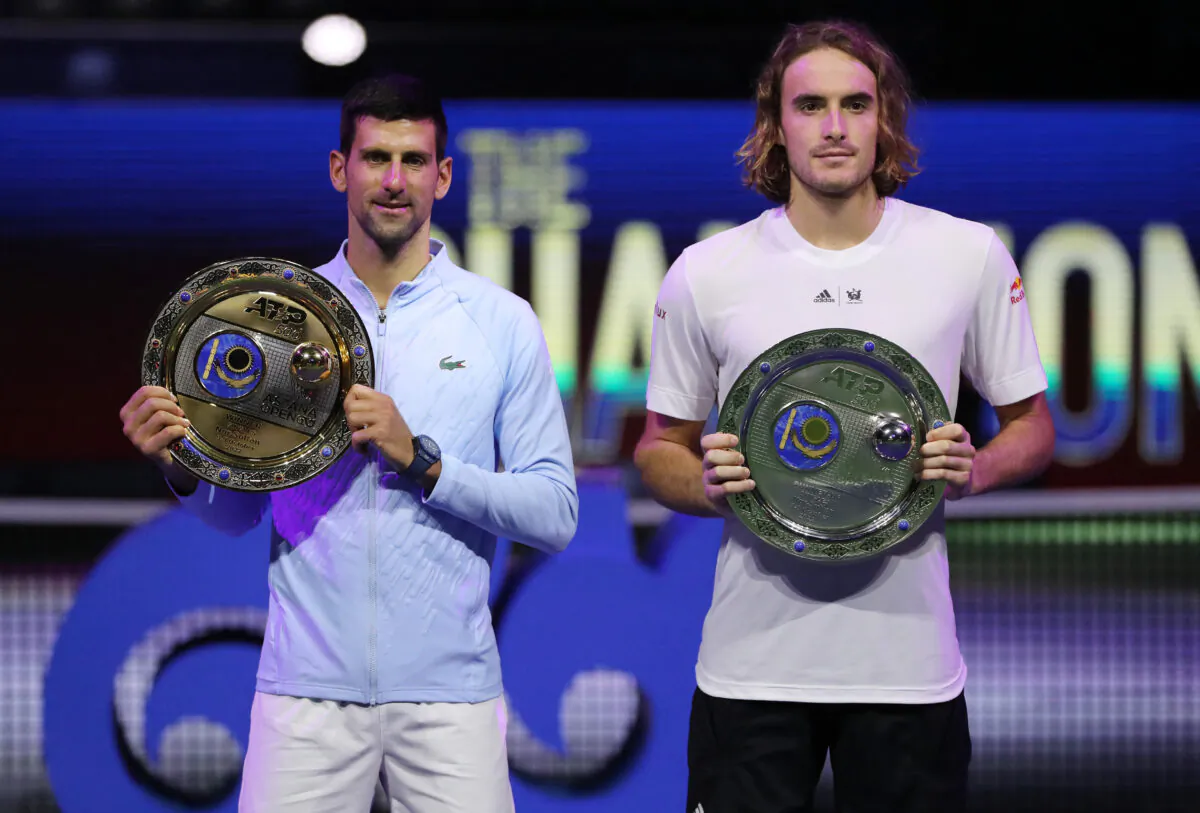 Serbia's Novak Djokovic (L) poses with a trophy after winning the men's singles final match against Greece's Stefanos Tsitsipas (R) at the Astana Open tennis tournament in Astana, Kazakhstan, on Oct. 9, 2022. (Pavel Mikheyev/Reuters)