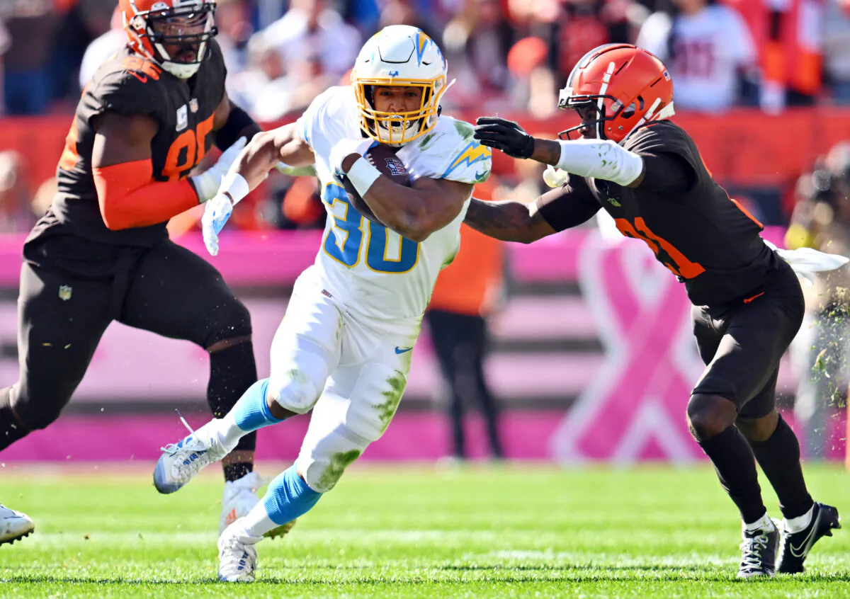 Denzel Ward (21) of the Cleveland Browns tackles Austin Ekeler (30) of the Los Angeles Chargers during the second quarter at FirstEnergy Stadium in Cleveland, on Oct. 9, 2022. (Jason Miller/Getty Images)