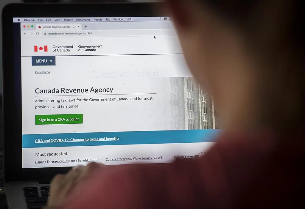 A person looks at a Canada Revenue Agency homepage, in Montreal on Aug. 16, 2020. (The Canadian Press/Graham Hughes)