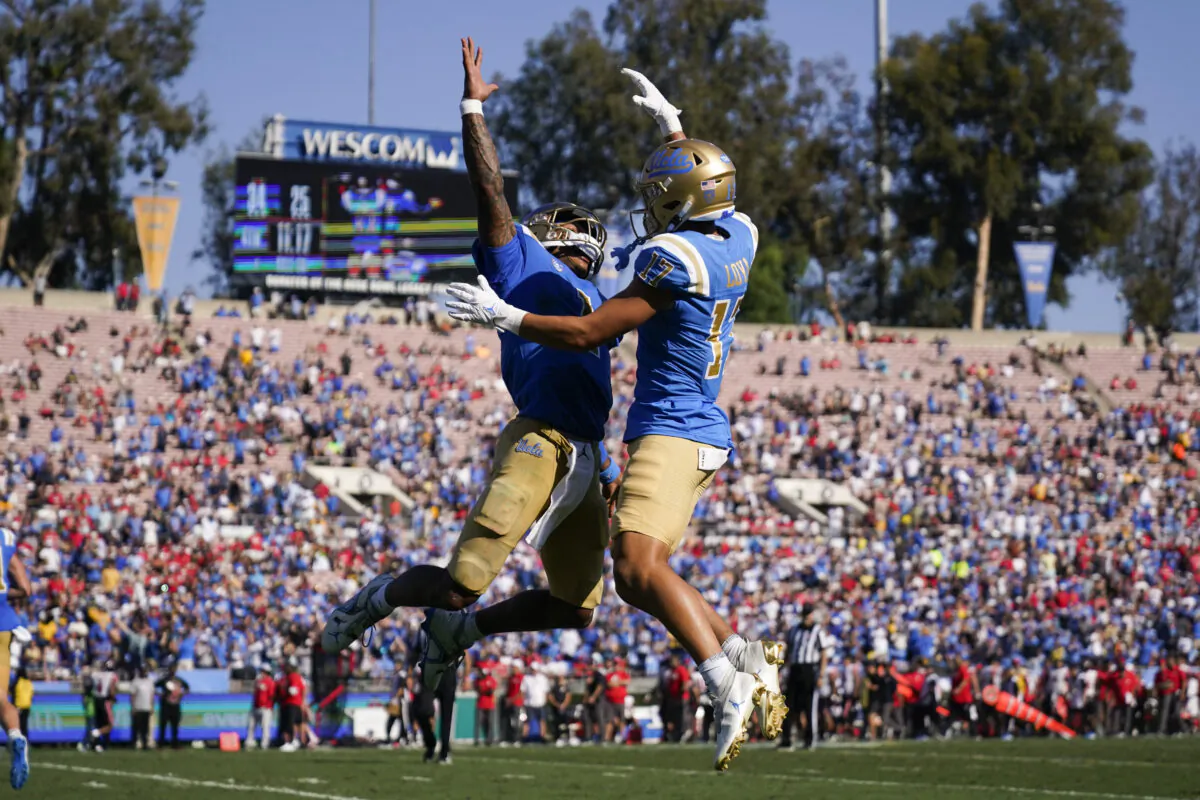 UCLA quarterback Dorian Thompson-Robinson (1) and wide receiver Logan Loya (17) celebrate after a touchdown during the second half of an NCAA college football game against Utah in Pasadena, Calif., on Oct. 8, 2022. (Ashley Landis/AP Photo)