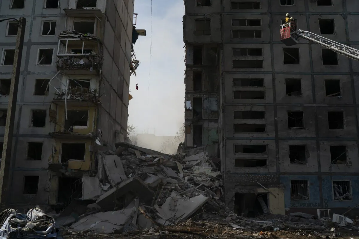 Firefighters work at the scene of a residential building that was heavily damaged after a Russian attack in Zaporizhzhia, Ukraine, on Oct. 9, 2022. (Leo Correa/AP Photo)