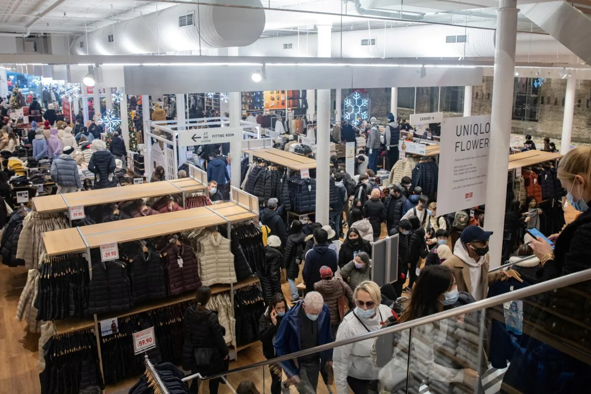 Shoppers walk at a store during Black Friday sales in the Manhattan borough of New York on Nov. 26, 2021. (Jeenah Moon/Reuters)