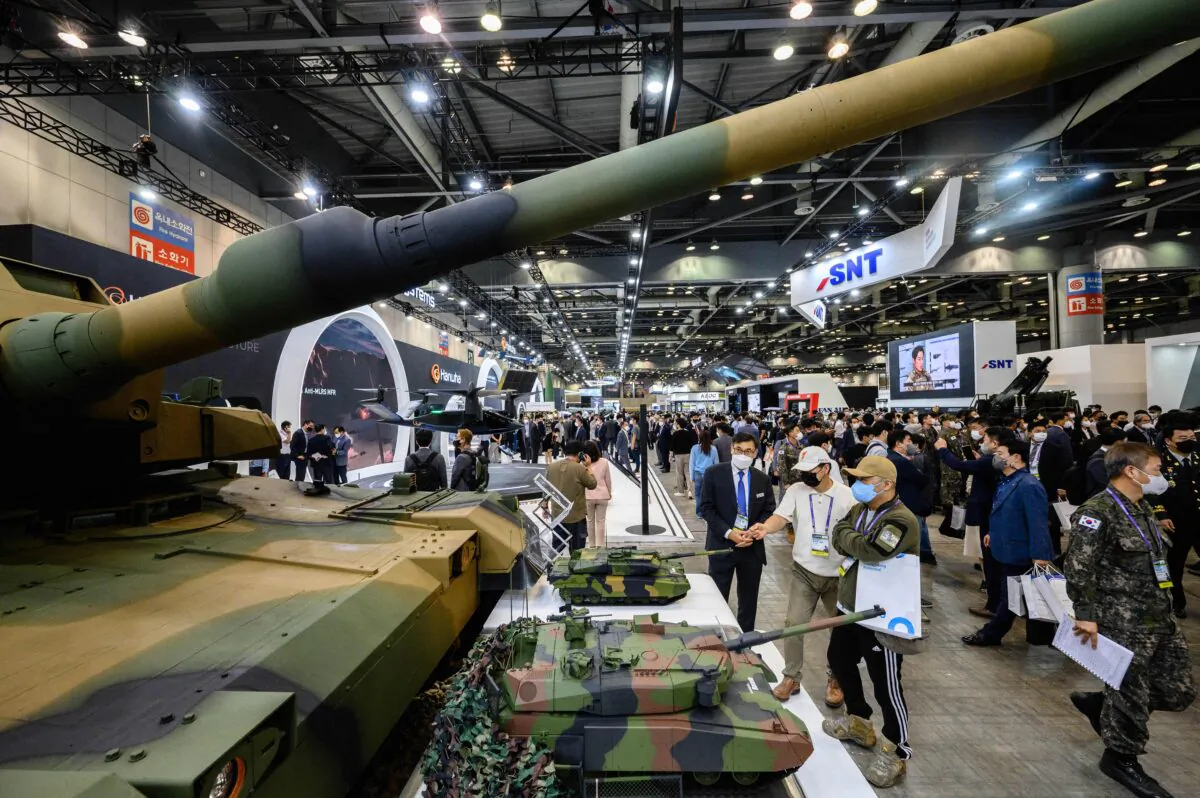 Visitors are seen beyond a K2 tank (foreground) during the Defense Expo Korea (DX Korea) in Goyang, west of Seoul, on Sept. 21, 2022. (Anthony Wallace/AFP via Getty Images)