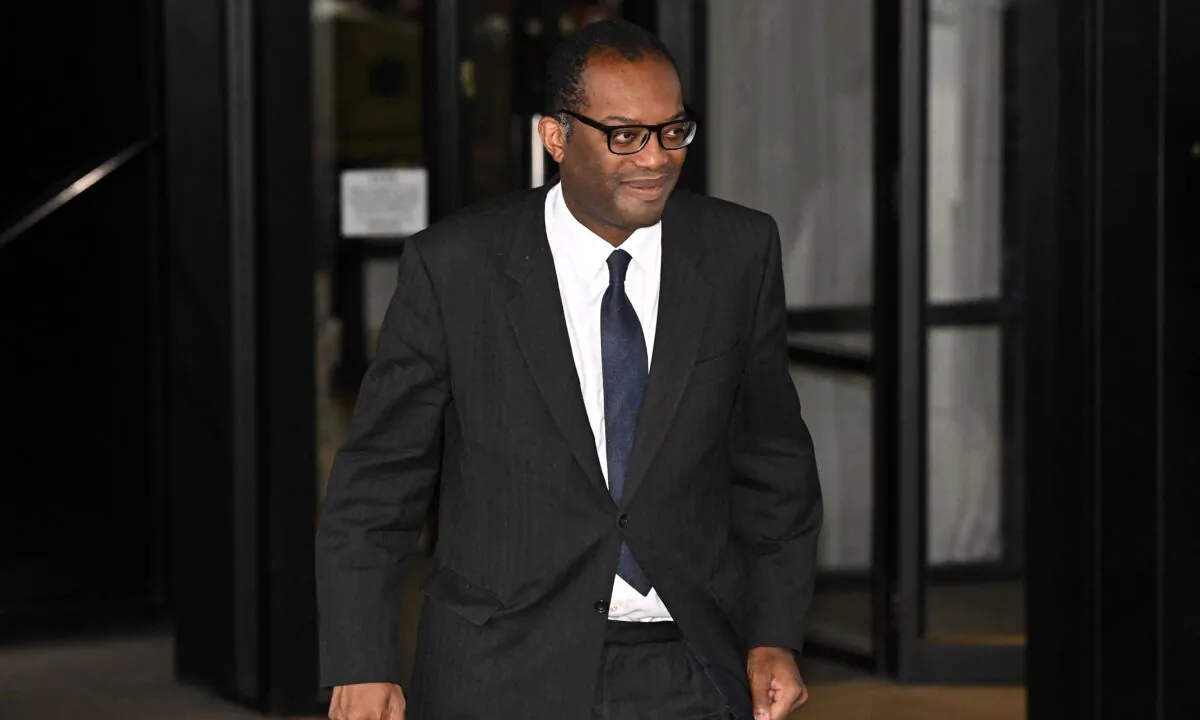 Britain's Chancellor of the Exchequer Kwasi Kwarteng follows Britain's Prime Minister Liz Truss out of her hotel on the third day of the annual Conservative Party Conference in Birmingham, central England, on Oct. 4, 2022. (Oli Scarff/AFP via Getty Images)