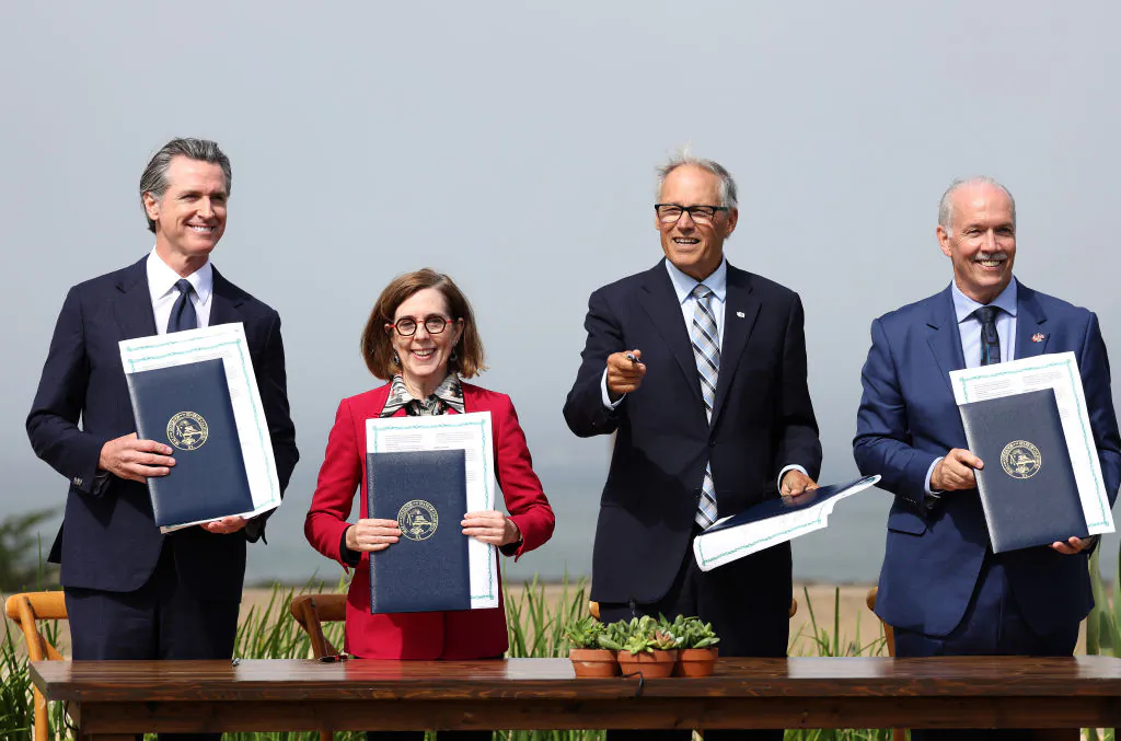 (L-R) California Gov. Gavin Newsom, Oregon Gov. Kate Brown, Washington Gov. Jay Inslee and British Columbia Premier John Horgan hold up signed climate agreements during a press conference in San Francisco on Oct. 6, 2022. (Justin Sullivan/Getty Images)
