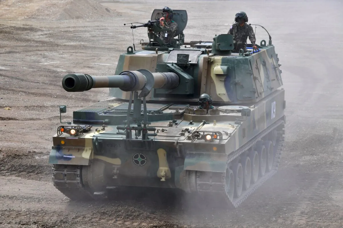 South Korean soldiers sit on the top of a K9 Thunder 155mm self-propelled Howitzer during an equipment demonstration at the Defense Expo Korea 2016 at KINTEX exhibition hall in Goyang, north of Seoul, on Sept. 10, 2016. (Jung Yeon-Je/AFP via Getty Images)