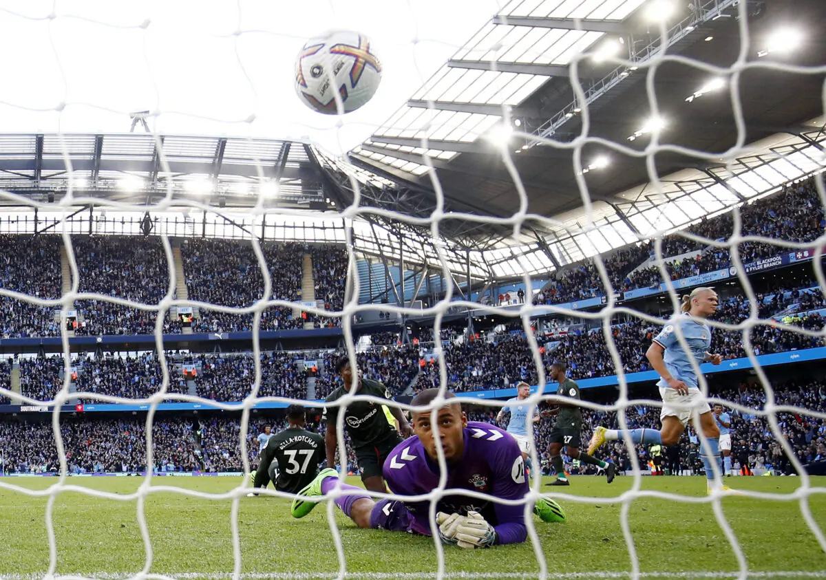 Manchester City's Erling Braut Haaland celebrates scoring their fourth goal as Southampton's Gavin Bazunu reacts during the Premier League match between Manchester City and Southampton FC at Etihad Stadium in Manchester, England, on Oct. 8, 2022. (Jason Cairnduff/Action Images via Reuters)
